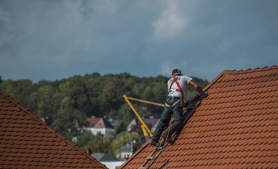 Professional working on roof installation